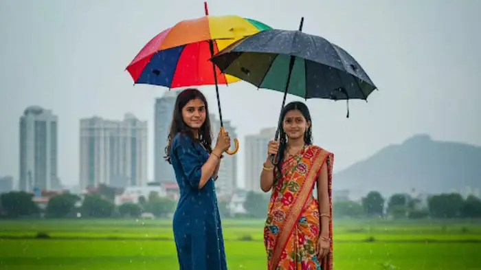 Two girls standing in heavy rain in India on 19 June 2025